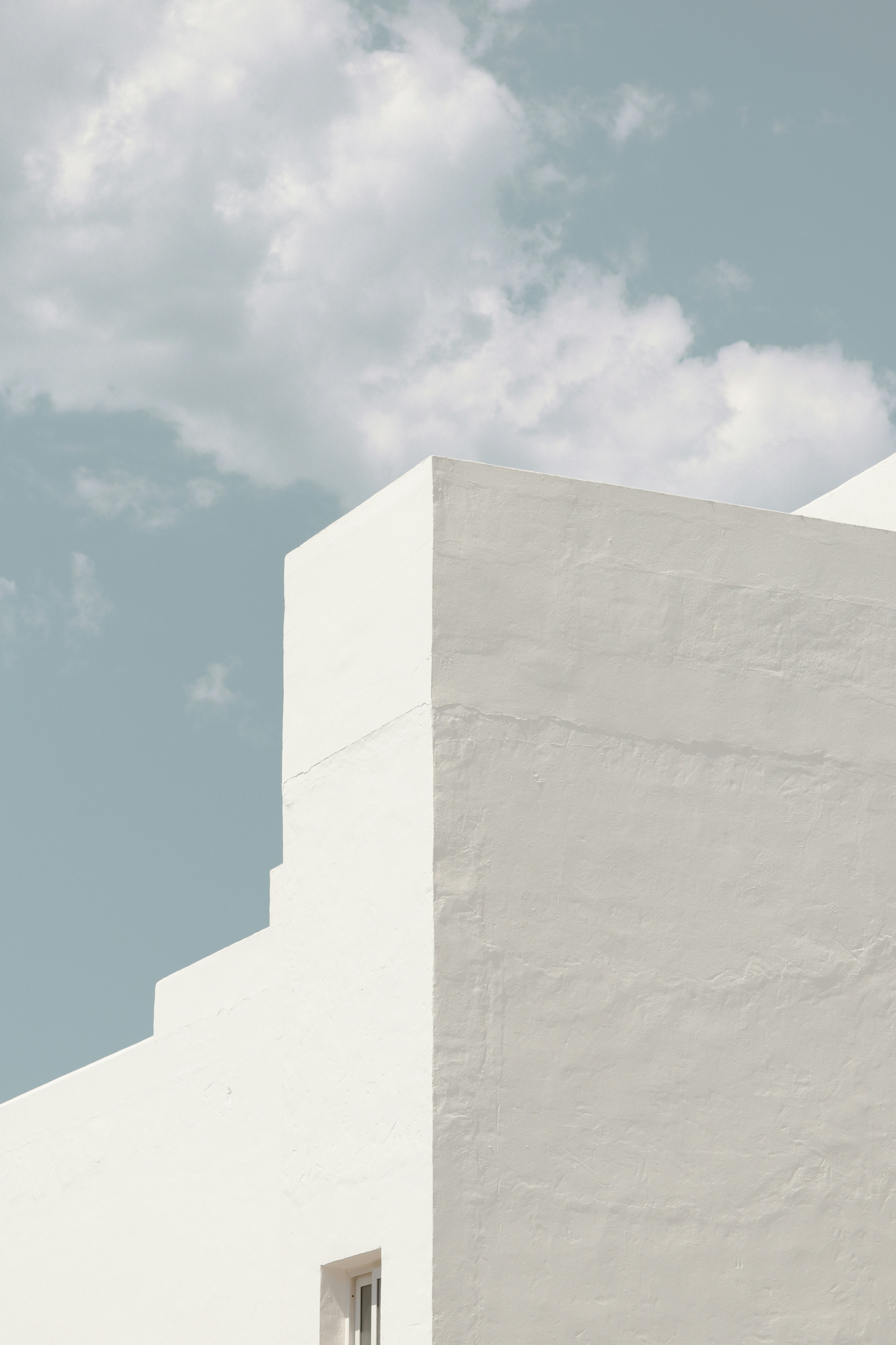 white concrete wall under blue sky during daytime